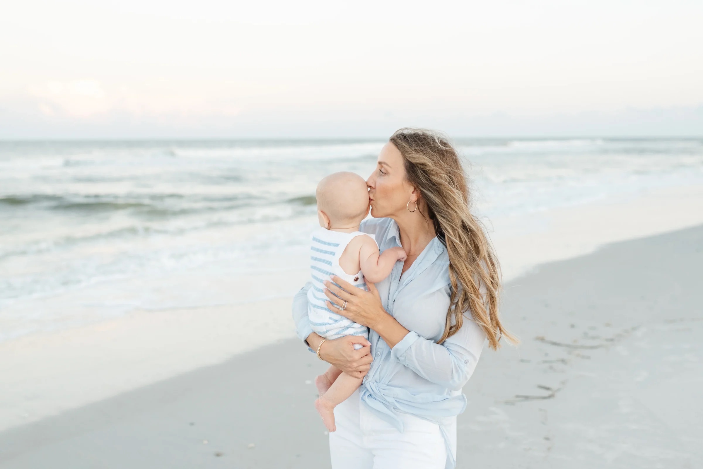 A mother holding her baby thinking about the importance of motherhood in photos.