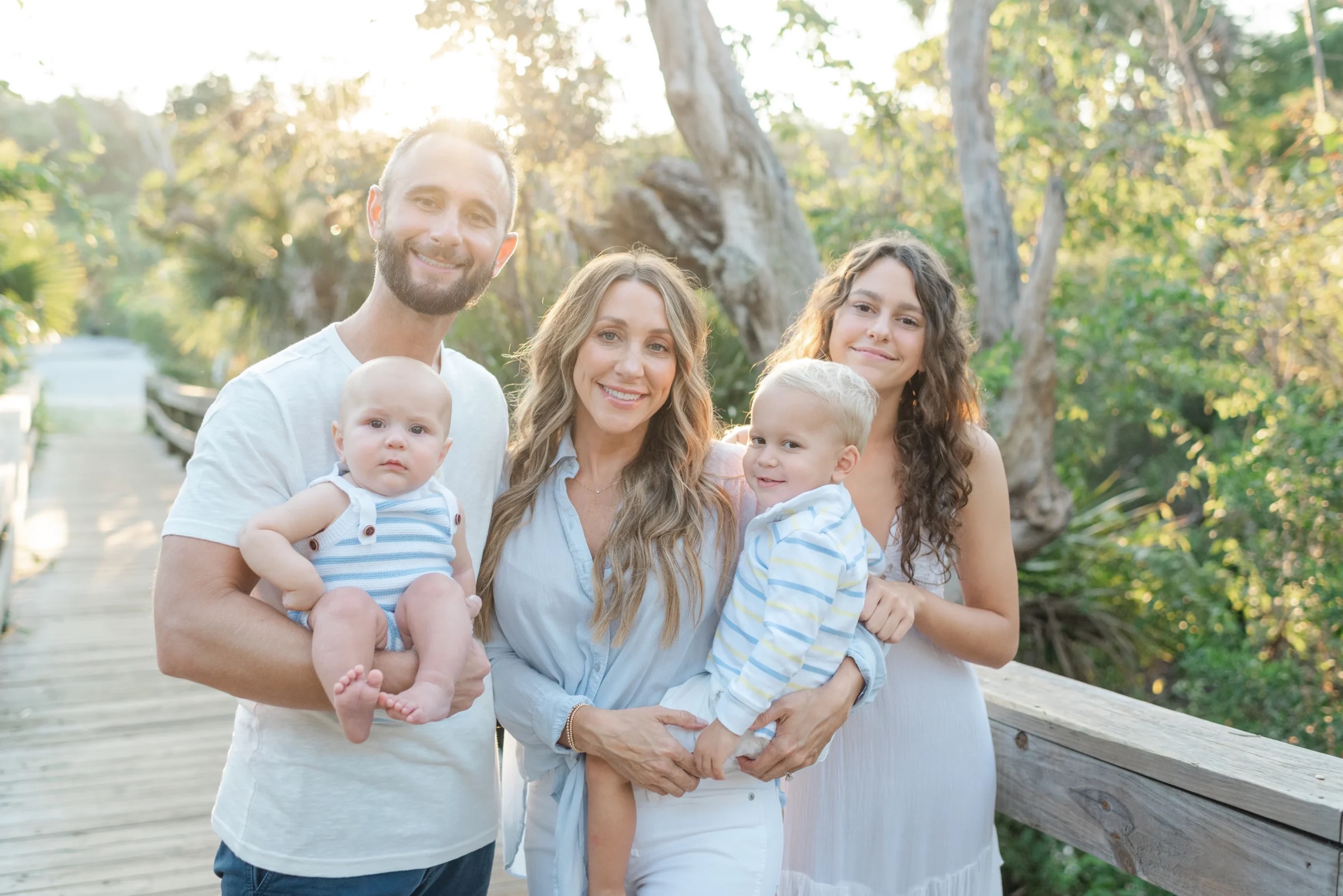 A family portrait with mother in the middle.