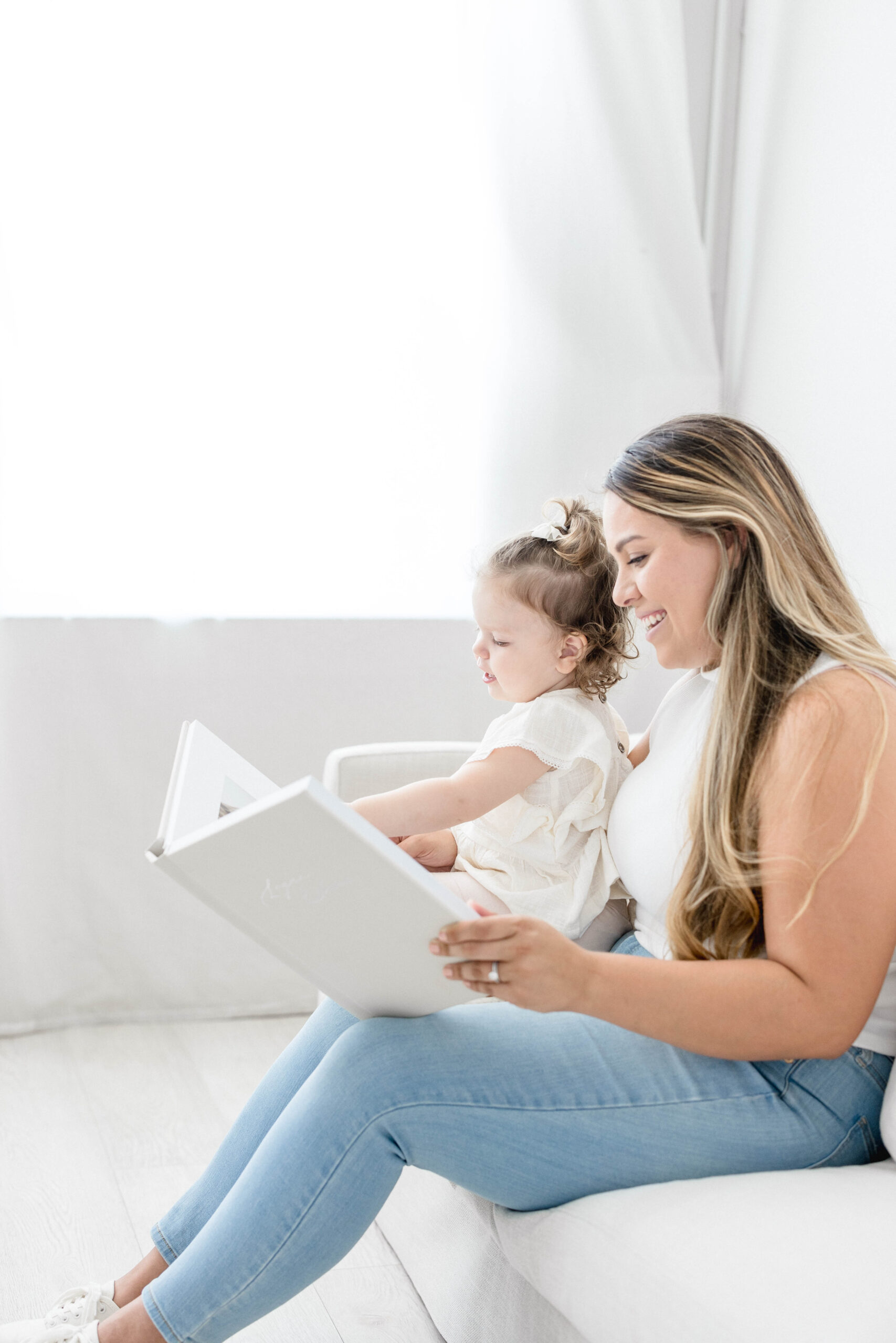 A mom and a little girl looking at their custom heirloom album