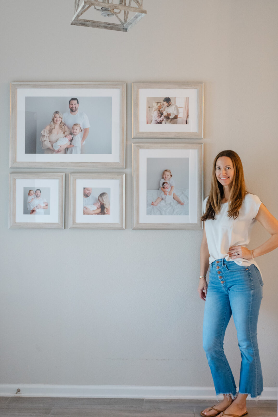 Custom artwork installation of a growing family framed wall gallery