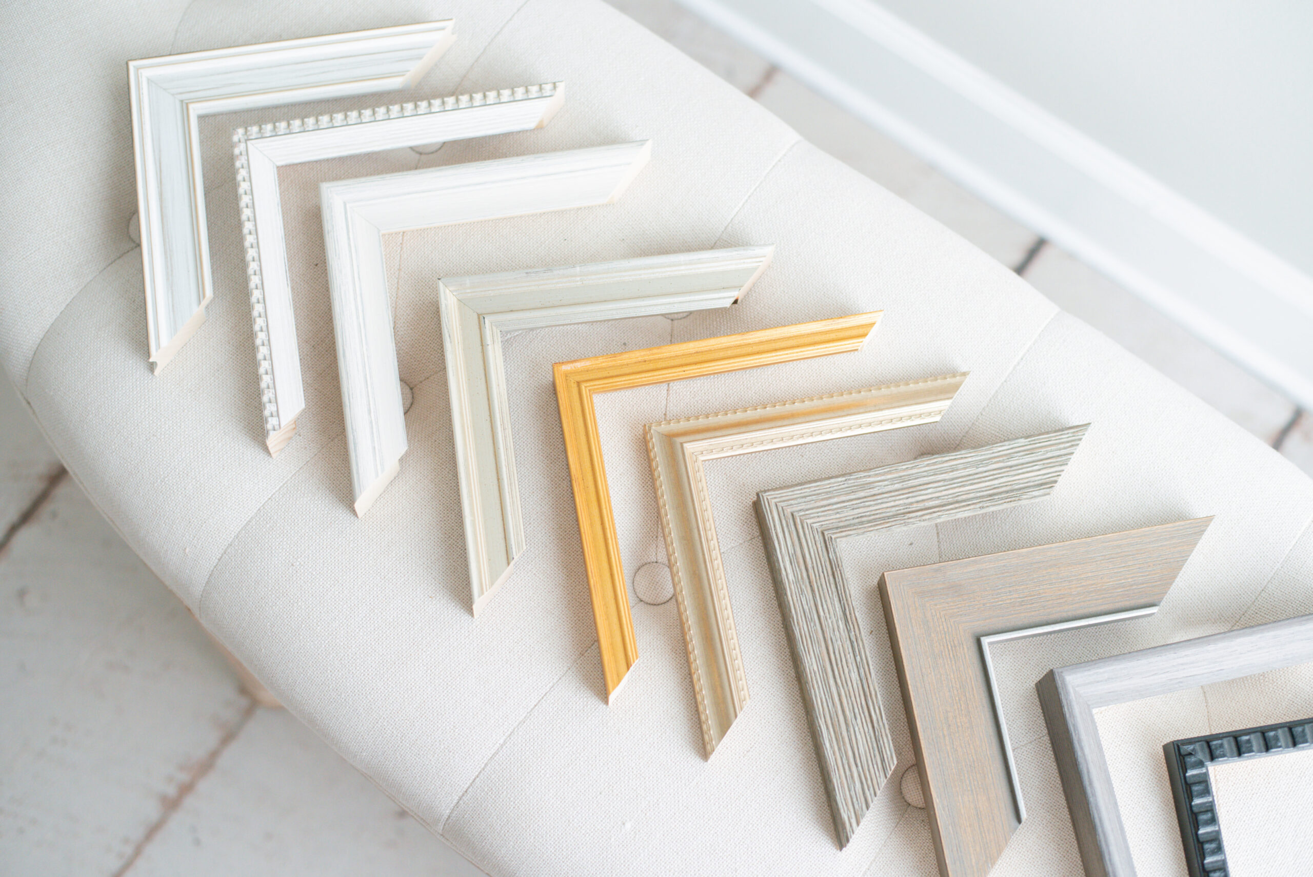 A selection of our curated frame molding collection used to create our custom artwork for our clients