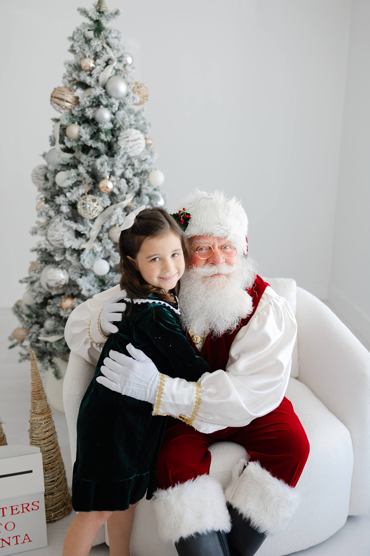 santa hugging little girl with green dress on