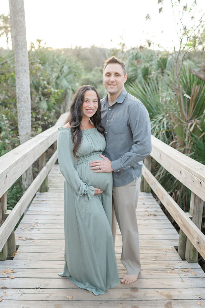 mom and dad posed for maternity photo at jacksonville beach