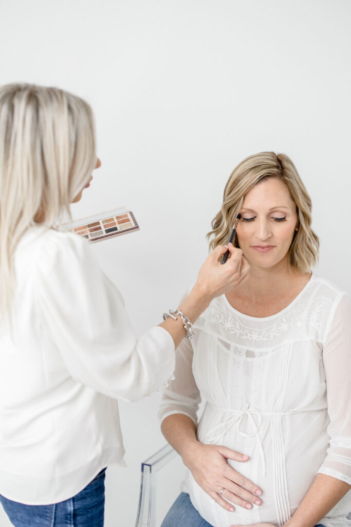 mom getting hair and make up for family photos