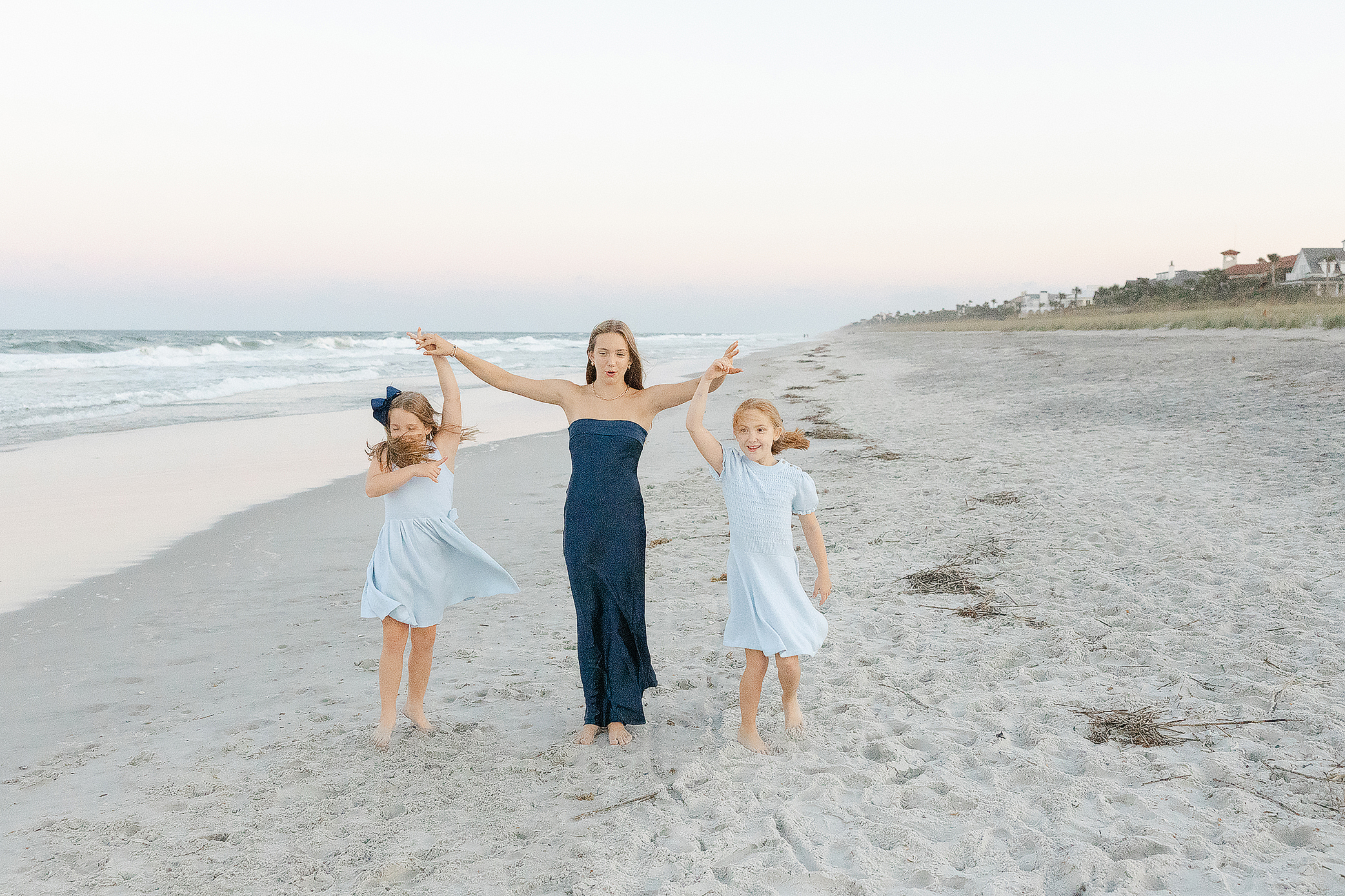 3 sisters on the beach, posing for the camera