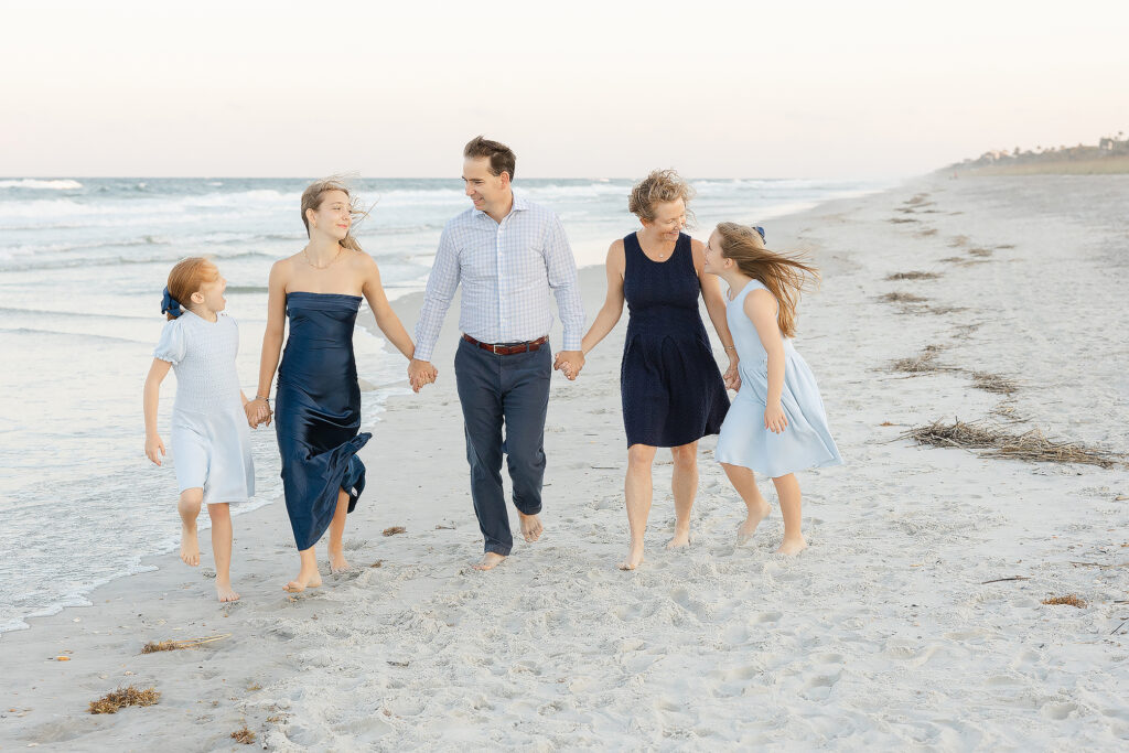 family walking at the beach for their jacksonville family photoshoot