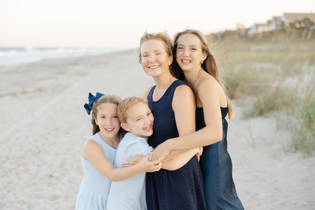 mom and daughters snuggling on a ponte vedra beach