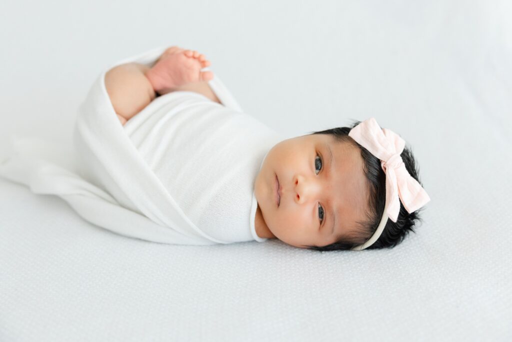 Newborn photography session in Jacksonville featuring baby in blanket
